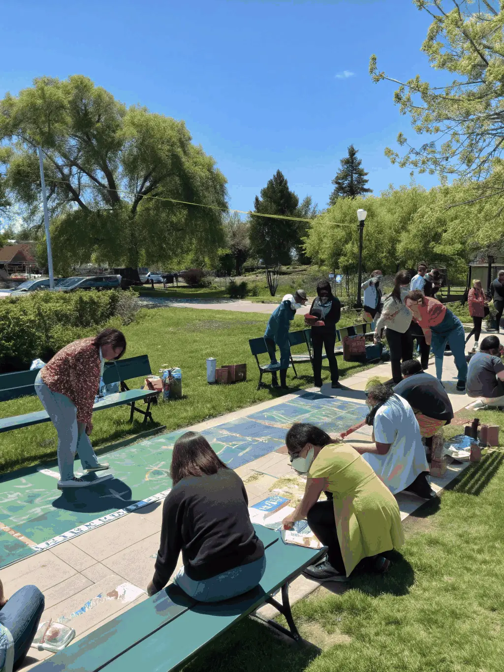 A group of artists and community members interacting at a cultural event, emphasizing the community engagement aspect of GOD'ART CREATION.